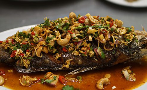 deep fried fish topped with thai herbs